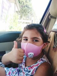 Portrait of girl sitting in car