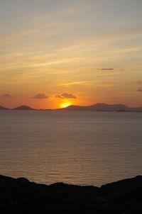 Scenic view of sea against romantic sky at sunset