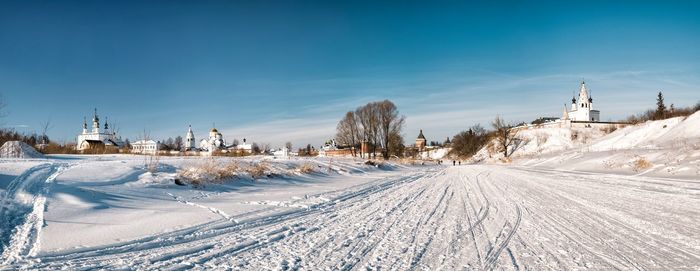 Snow covered land against sky