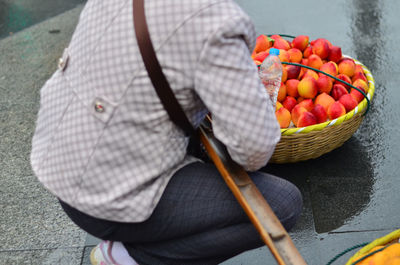 High angle view of man and fruits in basket