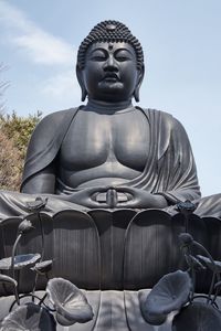 Statue of buddha against sky