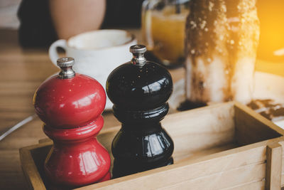 A pair of salt and pepper bottle in wood box nice to put on your dinner table