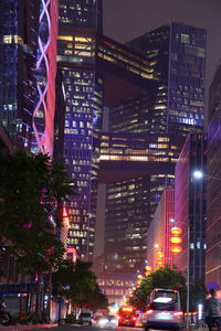 Illuminated city street and buildings at night