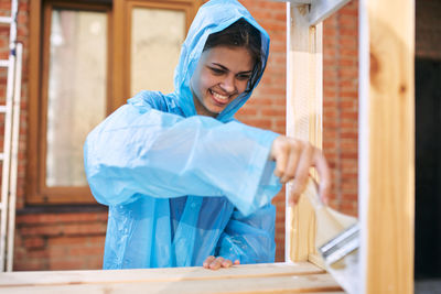 Portrait of young woman standing in workshop