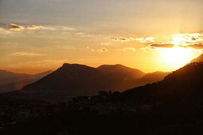 Scenic view of silhouette mountains against sky during sunset