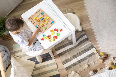 High angle view of woman sitting on table