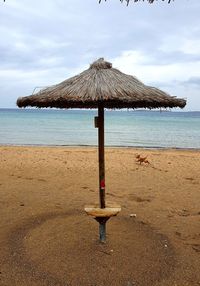 Lifeguard hut on beach against sky