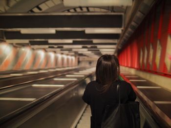 Rear view of woman standing in corridor