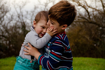 Mother and son with baby on tree