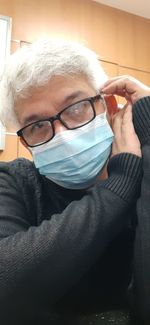 Close-up portrait of man wearing eyeglasses