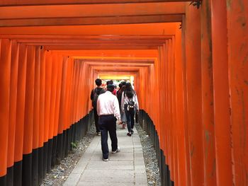 Rear view of people going through the tori-i gates