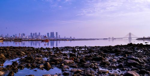 Scenic view of sea and buildings against sky