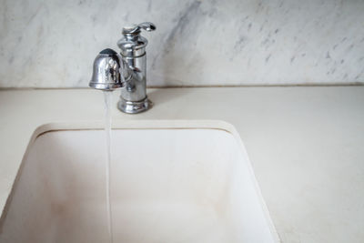 Close-up of faucet in bathroom