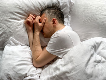 Middle aged man sleeping at home cozy bedroom bed vibes white alone early morning concept of comfort