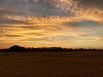 Scenic view of field against sky during sunset