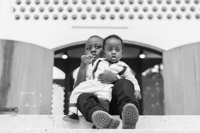 Portrait of friends sitting on man