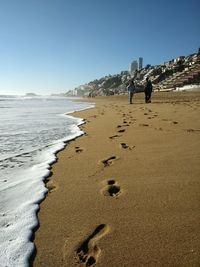 Scenic view of beach against clear sky