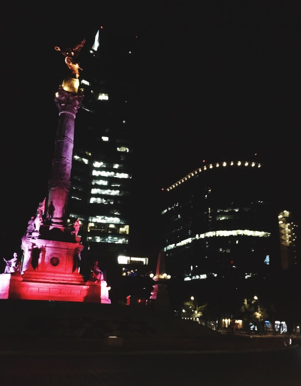 LOW ANGLE VIEW OF ILLUMINATED BUILDINGS AGAINST SKY