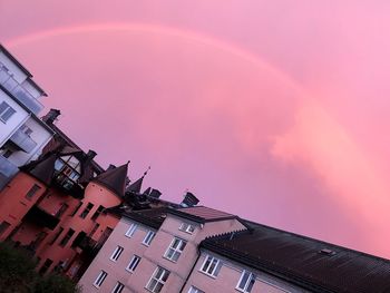 Low angle view of pink building against sky