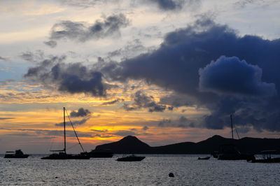 Scenic view of sea against dramatic sky during sunset