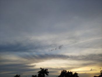 Low angle view of silhouette trees against sky at sunset