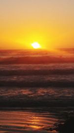 Scenic view of sea against romantic sky at sunset