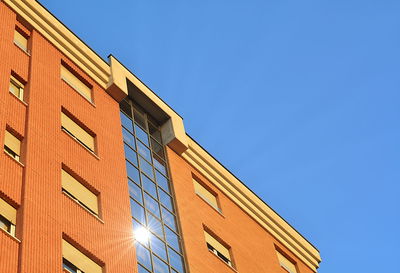 Low angle view of building against clear blue sky