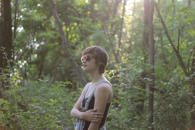 Woman wearing sunglasses in forest