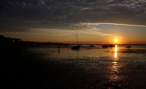 Scenic view of beach against sky during sunset