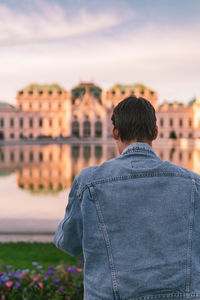 Rear view of man standing against buildings