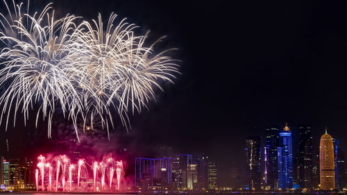 Low angle view of firework display at night