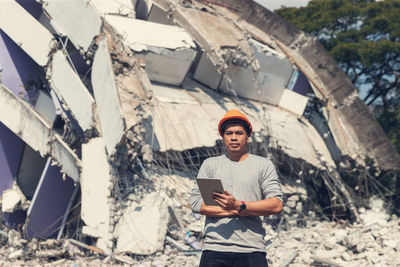 Portrait of young man standing on mobile phone