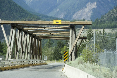 Road amidst trees and mountains