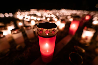 Close-up of illuminated tea light candles on table