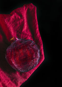 High angle view of red berries on black background