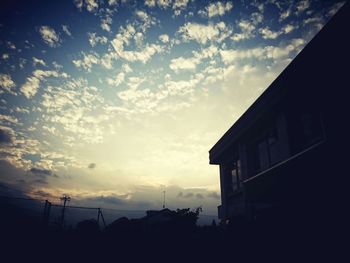 Low angle view of built structure against sky at sunset