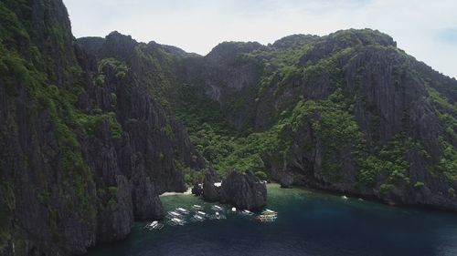 Scenic view of rocks and mountains against sky