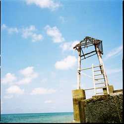 Low angle view of sea against blue sky