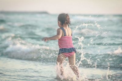 Full length of girl standing on beach