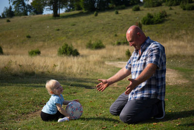 Rear view of two boys on grass