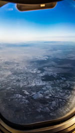 Aerial view of landscape with airplane window