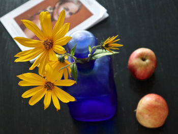 High angle view of yellow flowers on table