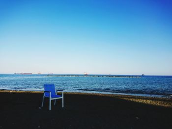 Scenic view of beach against clear blue sky