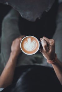 Midsection of woman holding coffee cup