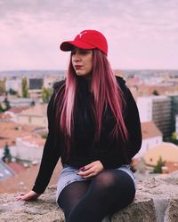 Beautiful young woman sitting outdoors