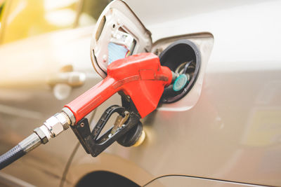 Close-up of pump filling fuel in car