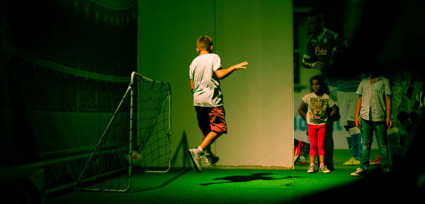 Rear view of boy standing in corridor