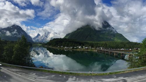 Panoramic shot of lake by mountains against sky
