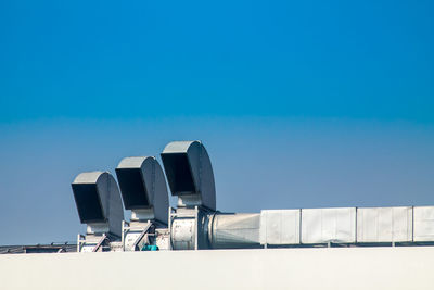 Low angle view of building against clear blue sky