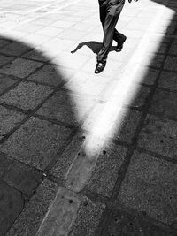 Low section of man walking on street